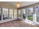 Carpeted sun room with large windows providing plenty of natural light and views of the trees at 6841 Fairway Ridge Dr, Douglasville, GA 30134