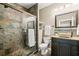 Stylish bathroom with a vessel sink, dark cabinets, and a tiled walk-in shower at 893 Paces Farm Sw Trl, Marietta, GA 30064