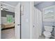 This well-lit bathroom has a toilet, and a view into an adjacent bedroom at 893 Paces Farm Sw Trl, Marietta, GA 30064