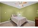 Comfortable bedroom with neutral carpet, a ceiling fan, and ample natural light at 893 Paces Farm Sw Trl, Marietta, GA 30064