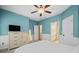 Bedroom featuring carpet, a ceiling fan, a TV, neutral wall color, a bed, and doorway leading into bathroom at 893 Paces Farm Sw Trl, Marietta, GA 30064