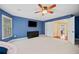 Large bedroom with a ceiling fan, bay windows, carpeted floor, a TV, closet, and double door opening at 893 Paces Farm Sw Trl, Marietta, GA 30064