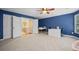 Bedroom with white walls, beige carpet, view of open door leading to hallway with black railing at 893 Paces Farm Sw Trl, Marietta, GA 30064