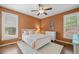 Cozy bedroom featuring hardwood floors, a ceiling fan, and bright windows at 893 Paces Farm Sw Trl, Marietta, GA 30064