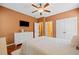 Comfortable bedroom with a ceiling fan, dresser, and view of an open door at 893 Paces Farm Sw Trl, Marietta, GA 30064