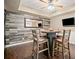 Cozy dining area featuring a barrel table, bar stools, and a rustic wood accent wall at 893 Paces Farm Sw Trl, Marietta, GA 30064