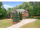 Charming two-story brick home with well-manicured lawn, three car garage, and beautiful landscaping at 893 Paces Farm Sw Trl, Marietta, GA 30064