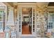 Elegant entryway showcasing stone accents, sidelights, and a glimpse into the home's hardwood floors at 893 Paces Farm Sw Trl, Marietta, GA 30064