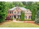 Charming brick and stone home with a well-manicured lawn and inviting walkway at 893 Paces Farm Sw Trl, Marietta, GA 30064