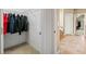 Hallway with tile floor, closet, and doorway into another room, with natural light coming from the window at 893 Paces Farm Sw Trl, Marietta, GA 30064