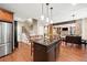 View of the kitchen island that features granite countertops with seating and is open to the living room at 893 Paces Farm Sw Trl, Marietta, GA 30064