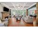 Spacious living room features a stone fireplace, coffered ceiling, and large windows with backyard views at 893 Paces Farm Sw Trl, Marietta, GA 30064