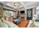 Open-concept living room with stone accents, coffered ceilings, and plenty of natural light at 893 Paces Farm Sw Trl, Marietta, GA 30064