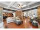 Spacious living room with hardwood floors, stone columns and view of kitchen and dining area at 893 Paces Farm Sw Trl, Marietta, GA 30064