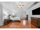 A primary bedroom with hardwood floors, a tray ceiling and large windows at 893 Paces Farm Sw Trl, Marietta, GA 30064