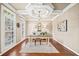 Bright and airy home office with plantation shutters, hardwood floors, and a decorative tray ceiling at 893 Paces Farm Sw Trl, Marietta, GA 30064