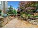Outdoor kitchen and patio with a stone fireplace, grill, and manicured landscaping at 893 Paces Farm Sw Trl, Marietta, GA 30064