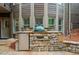 Stone outdoor kitchen featuring a grill, refrigerator, sink, and ample counter space at 893 Paces Farm Sw Trl, Marietta, GA 30064