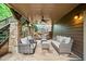 Covered outdoor patio with comfortable seating, stone pillars, and ceiling fan at 893 Paces Farm Sw Trl, Marietta, GA 30064