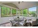 Screened-in porch features outdoor seating and wooded backyard views at 893 Paces Farm Sw Trl, Marietta, GA 30064