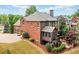 Brick home featuring a screened porch, back yard, 3-car garage, and stone landscaping with outdoor fireplace at 893 Paces Farm Sw Trl, Marietta, GA 30064