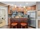 The wet bar features stainless steel appliances, a custom backsplash, granite countertops, and an island bar at 893 Paces Farm Sw Trl, Marietta, GA 30064
