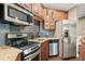 Modern wet bar area featuring stainless steel appliances, custom backsplash, and granite countertops at 893 Paces Farm Sw Trl, Marietta, GA 30064