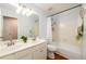 Bright bathroom featuring double sink vanity, bathtub with shower, and wood flooring at 3545 River Summit Trl, Duluth, GA 30097