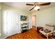 Aesthetic bedroom with wood floors, chair, and a mounted TV at 3545 River Summit Trl, Duluth, GA 30097