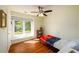Cozy bedroom with natural light from window, wood floors, and ceiling fan at 3545 River Summit Trl, Duluth, GA 30097