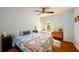 Bright bedroom with blue walls, a large window, and hardwood floors at 3545 River Summit Trl, Duluth, GA 30097