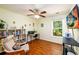 Bright bedroom space with workspace, bookshelf, and a view from the window at 3545 River Summit Trl, Duluth, GA 30097