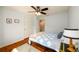 Bedroom features wood floors, soft blue walls, and a ceiling fan at 3545 River Summit Trl, Duluth, GA 30097