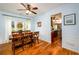 Sunlit dining room with hardwood floors that connect to the kitchen area at 3545 River Summit Trl, Duluth, GA 30097