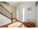 Inviting entryway with hardwood floors, staircase, and a cozy bench at 3545 River Summit Trl, Duluth, GA 30097
