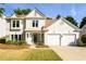Charming two-story home with stucco exterior, well-manicured lawn, and a two-car garage at 3545 River Summit Trl, Duluth, GA 30097