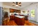 Well-lit kitchen features stainless steel appliances, a center island, and wood floors at 3545 River Summit Trl, Duluth, GA 30097
