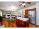 Spacious kitchen with an island and stainless appliances adjoins the living area at 3545 River Summit Trl, Duluth, GA 30097