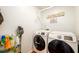 Functional laundry room with washer, dryer, and practical storage solutions at 3545 River Summit Trl, Duluth, GA 30097