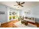 Bright living room featuring hardwood floors, neutral decor, and large windows at 3545 River Summit Trl, Duluth, GA 30097