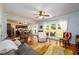 Cozy living room features hardwood floors, ceiling fan, and bright windows to the outdoors at 3545 River Summit Trl, Duluth, GA 30097