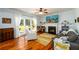 Warm living room with hardwood floors, fireplace, and ample natural light at 3545 River Summit Trl, Duluth, GA 30097