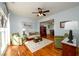 Comfortable living room with hardwood floors, ceiling fan, and large windows at 3545 River Summit Trl, Duluth, GA 30097