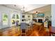 Open concept living and dining areas with hardwood floors, fireplace and backyard access at 3545 River Summit Trl, Duluth, GA 30097