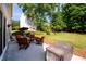 Cozy patio with outdoor seating, grill, and beautifully landscaped backyard at 3545 River Summit Trl, Duluth, GA 30097