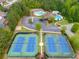 Aerial shot showcasing community tennis courts, pools, and clubhouse nestled in lush greenery at 36 Evergreen Way, Dallas, GA 30157