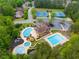 Aerial view of a stunning community with pools, tennis courts, a clubhouse, and lush greenery at 36 Evergreen Way, Dallas, GA 30157