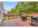 Backyard featuring a table and chair set for four, a barbecue, and a wooden fence at 36 Evergreen Way, Dallas, GA 30157