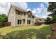 Spacious backyard with a well-maintained lawn, privacy fence, and a wooden deck with outdoor seating at 36 Evergreen Way, Dallas, GA 30157
