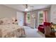 Cozy bedroom featuring soft carpet, a red chair, and a charming floral patterned bed set at 36 Evergreen Way, Dallas, GA 30157